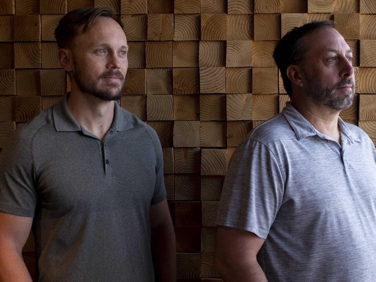 Two Neighborhood Ventures founders photographed against a slatted timber wall for azcentral