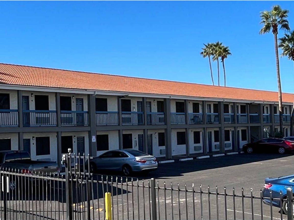 The two-storey Mesa hotel, with tile roof and blue balcony railings, that Neighborhood Ventures is converting into apartments